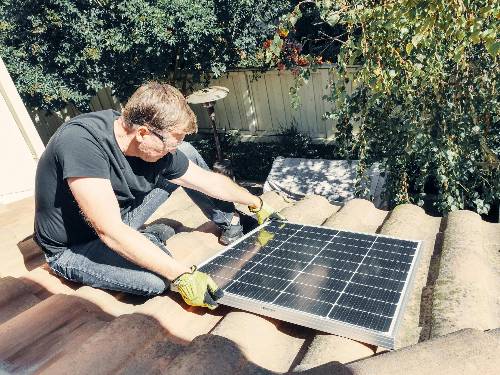 A Royal Peak Roofing team member discussing a roof deck inspection with a homeowner in front of a ranch-style house in Wilmington, Massachusetts.